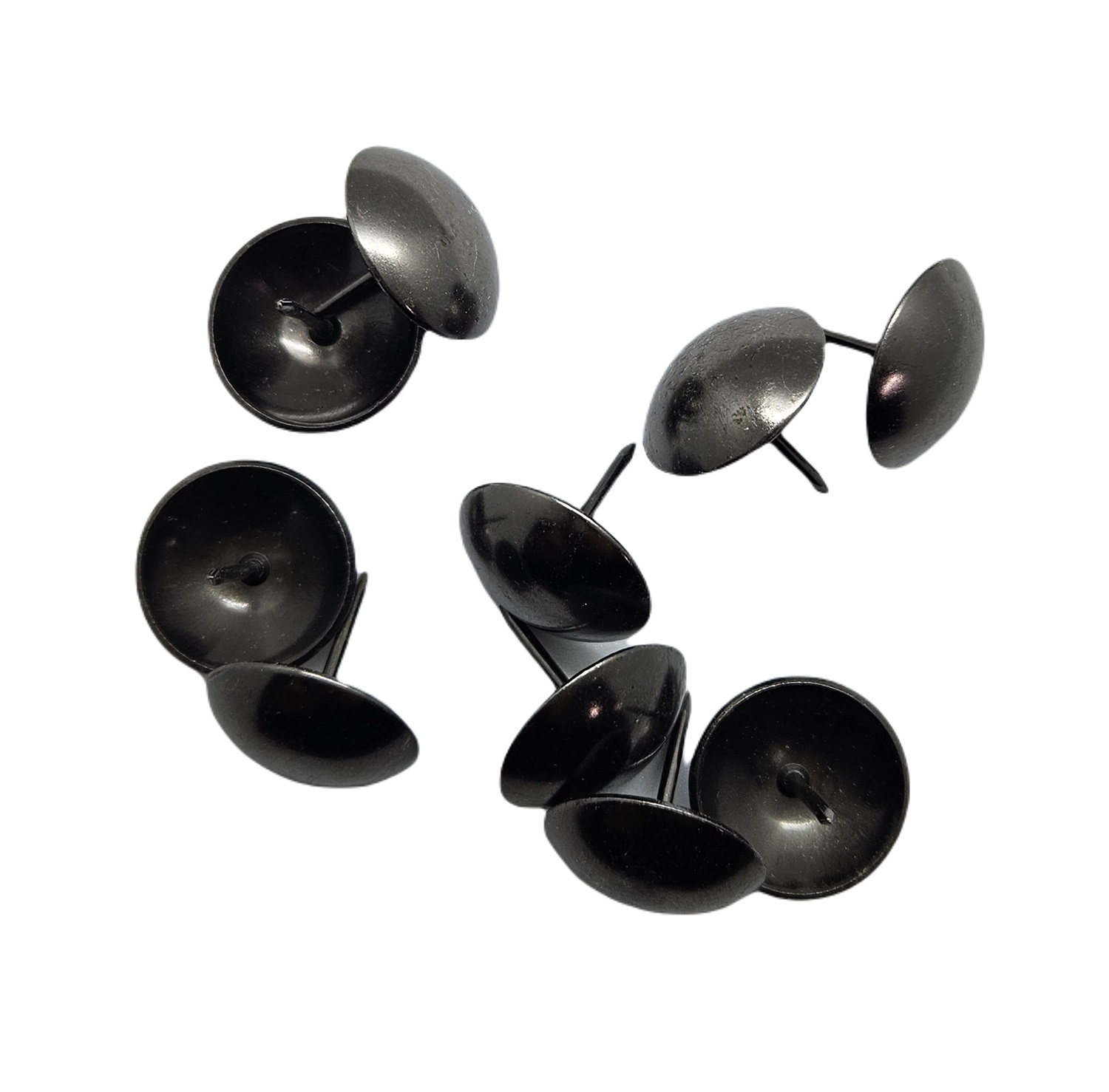Black round upholstery tacks or furniture nails on white background.