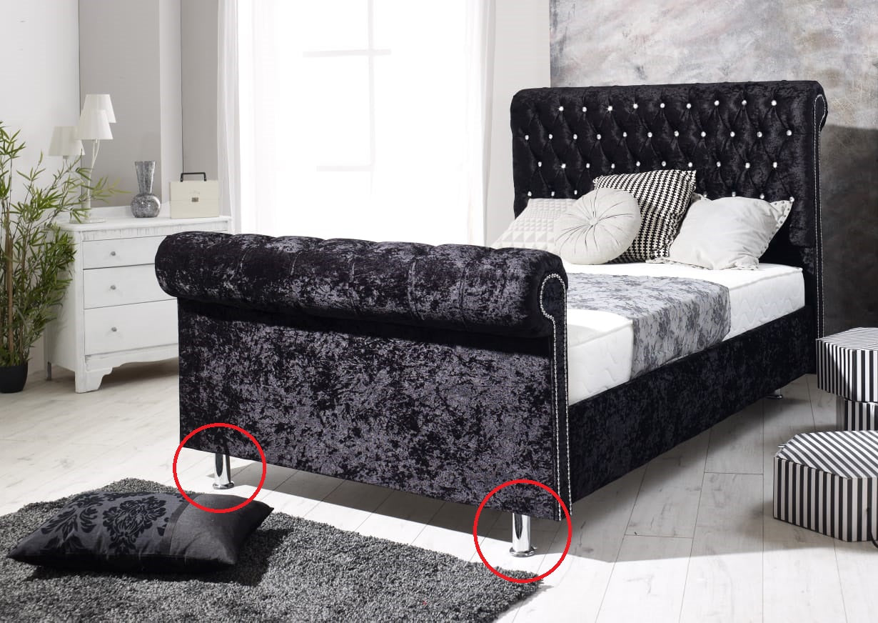 Chrome cylindrical feet/legs of the bed frame.