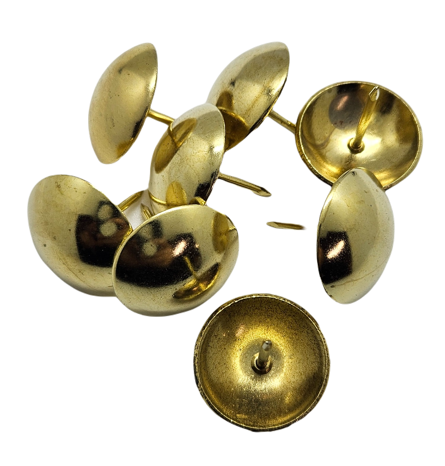Set of brass round upholstery tacks or furniture nails on white background.