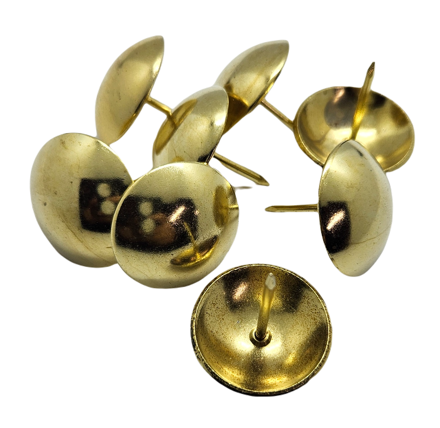 Close-up of large brass upholstery nails with round domed heads, arranged on a white background.